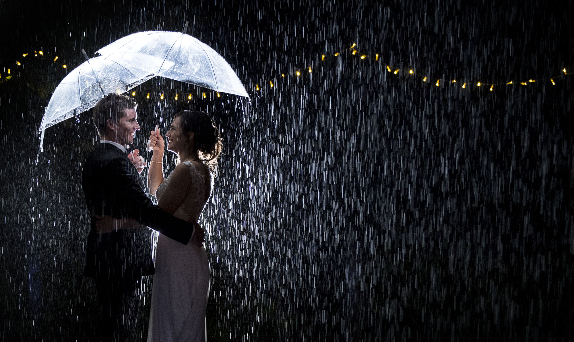 bride and groom raining at night